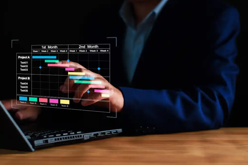 Project manager working on tablet and updating tasks and milestones progress planning with gantt