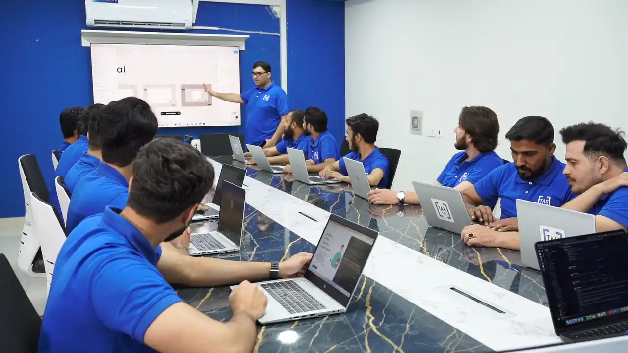 TAK Devs team collaborating on software development and digital solutions in office